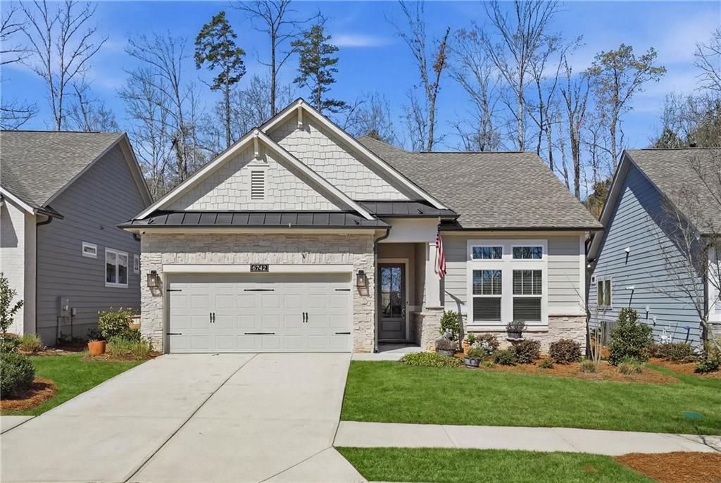 6742 Welcome Road Flowery Branch, GA 30542 - Photo 3 of 48 a front view of a house with a yard