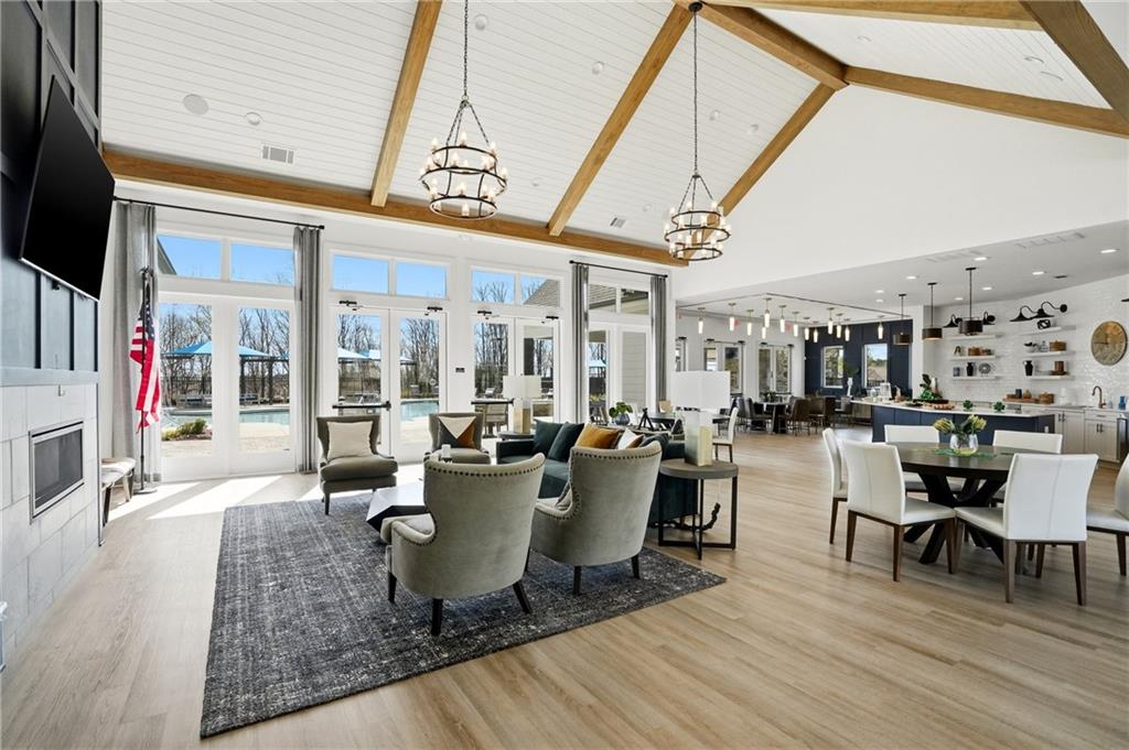 6742 Welcome Road Flowery Branch, GA 30542 - Photo 34 of 48 a living room with lots of furniture and a large window