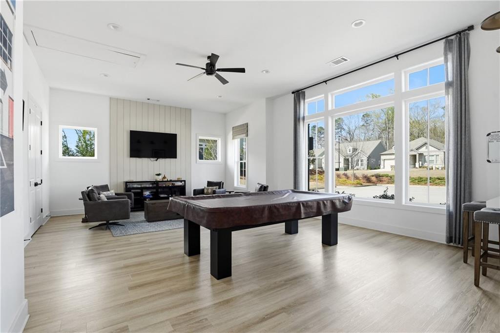 6742 Welcome Road Flowery Branch, GA 30542 - Photo 35 of 48 a view of a workspace with furniture window and wooden floor