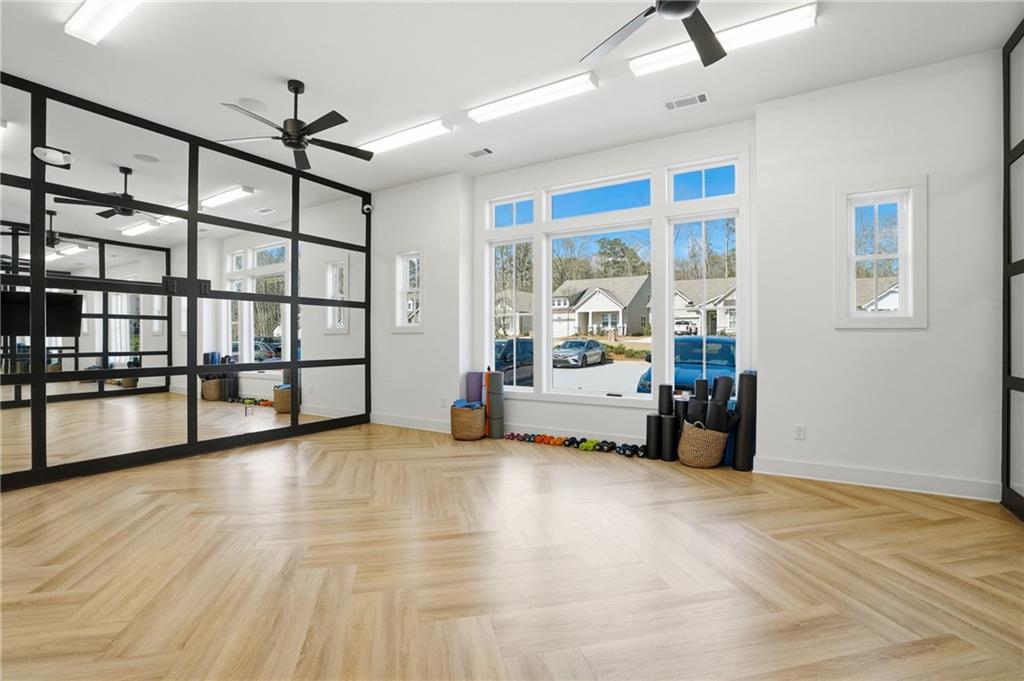 6742 Welcome Road Flowery Branch, GA 30542 - Photo 37 of 48 a view of a livingroom with furniture and a ceiling fan
