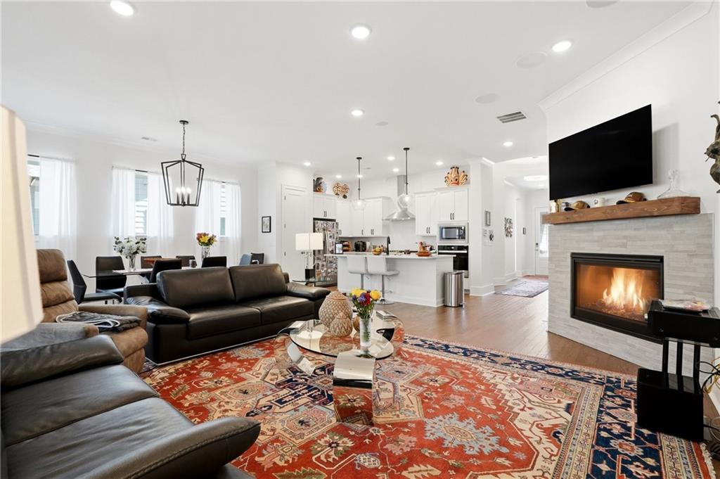 6742 Welcome Road Flowery Branch, GA 30542 - Photo 6 of 48 a living room with furniture and a flat screen tv