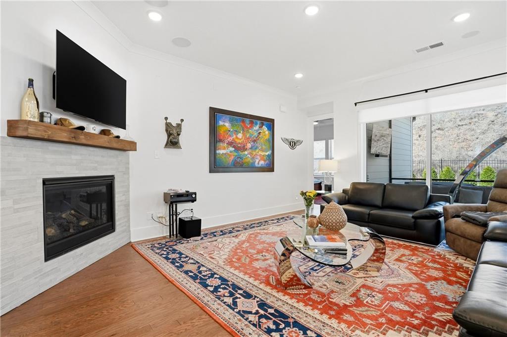 6742 Welcome Road Flowery Branch, GA 30542 - Photo 8 of 48 a living room with furniture and a flat screen tv