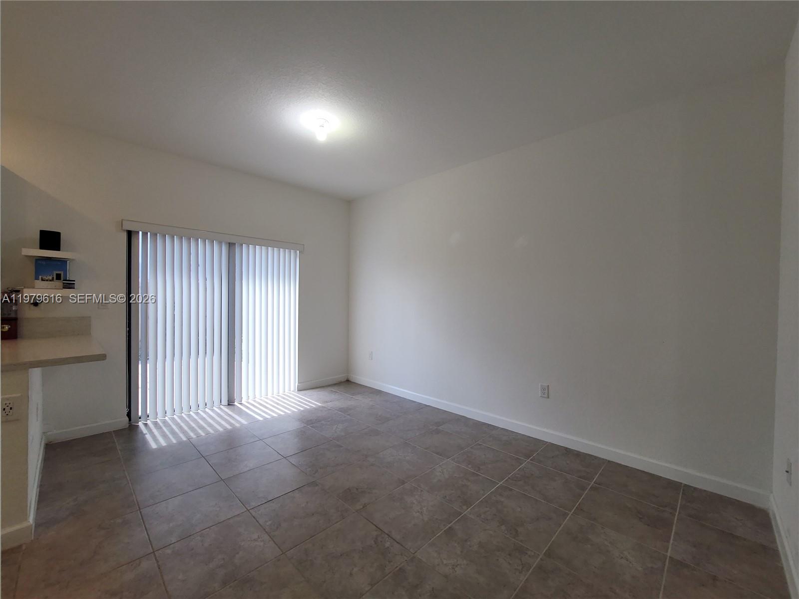 25039 Southwest 114th Avenue Homestead, FL 33032 - Photo 14 of 45 an empty room with a kitchen