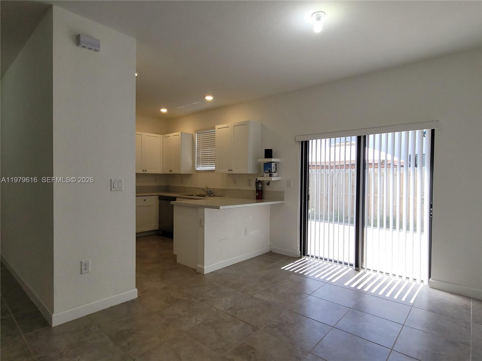 25039 Southwest 114th Avenue Homestead, FL 33032 - Photo 15 of 45 a view of a kitchen with a sink and cabinets