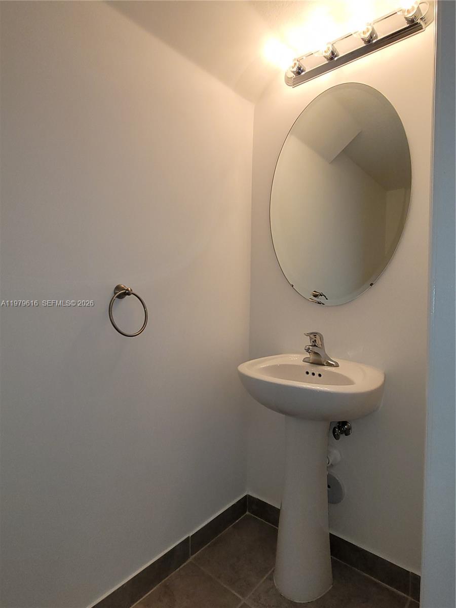 25039 Southwest 114th Avenue Homestead, FL 33032 - Photo 17 of 45 a bathroom with a sink and mirror