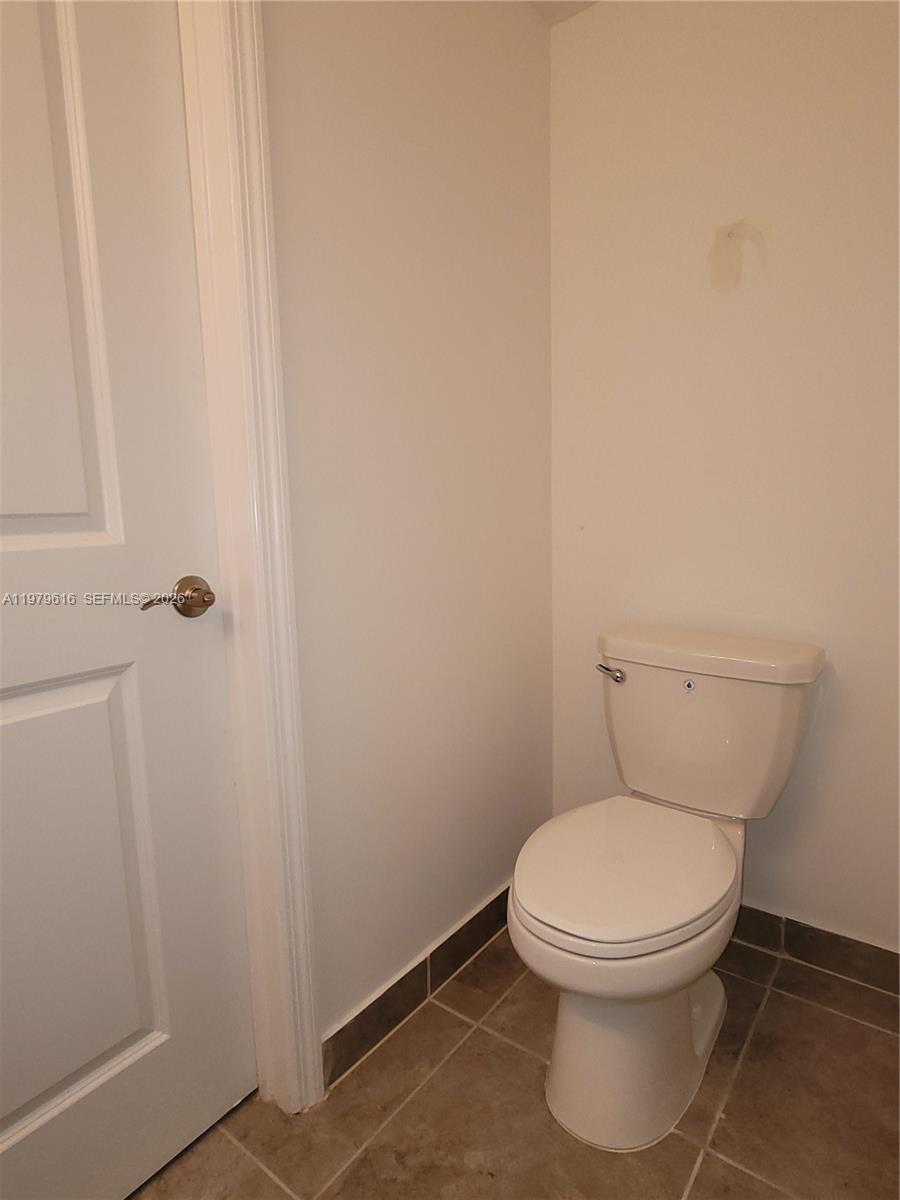 25039 Southwest 114th Avenue Homestead, FL 33032 - Photo 18 of 45 a white toilet sitting next to a shower