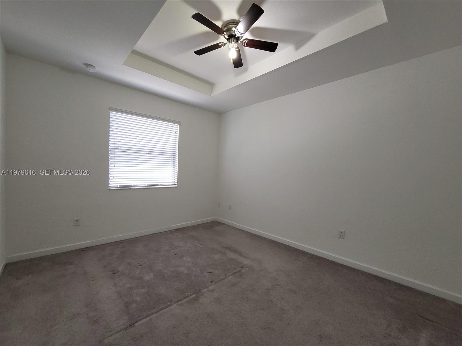 25039 Southwest 114th Avenue Homestead, FL 33032 - Photo 25 of 45 an empty room with a window and a fan
