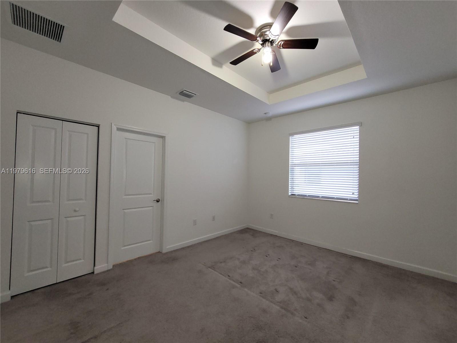 25039 Southwest 114th Avenue Homestead, FL 33032 - Photo 28 of 45 an empty room with a ceiling fan and a window