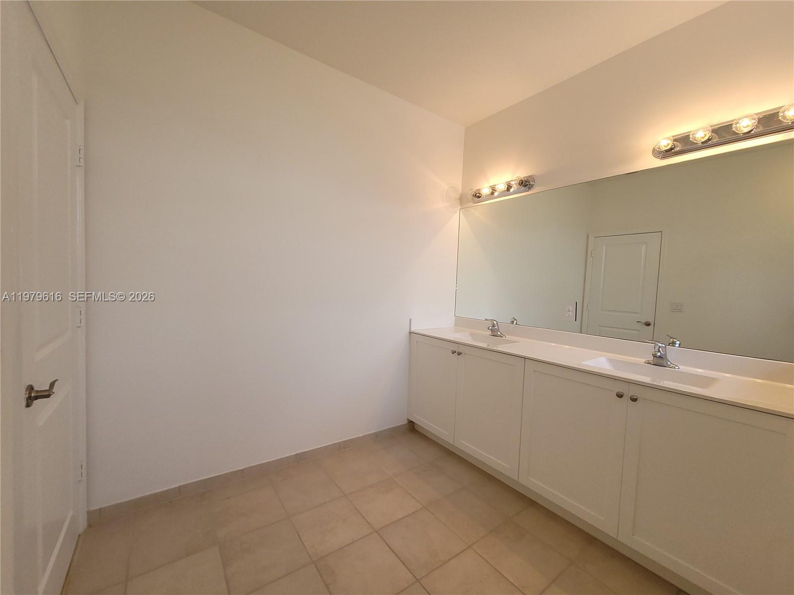 25039 Southwest 114th Avenue Homestead, FL 33032 - Photo 35 of 45 a bathroom with a sink and mirror
