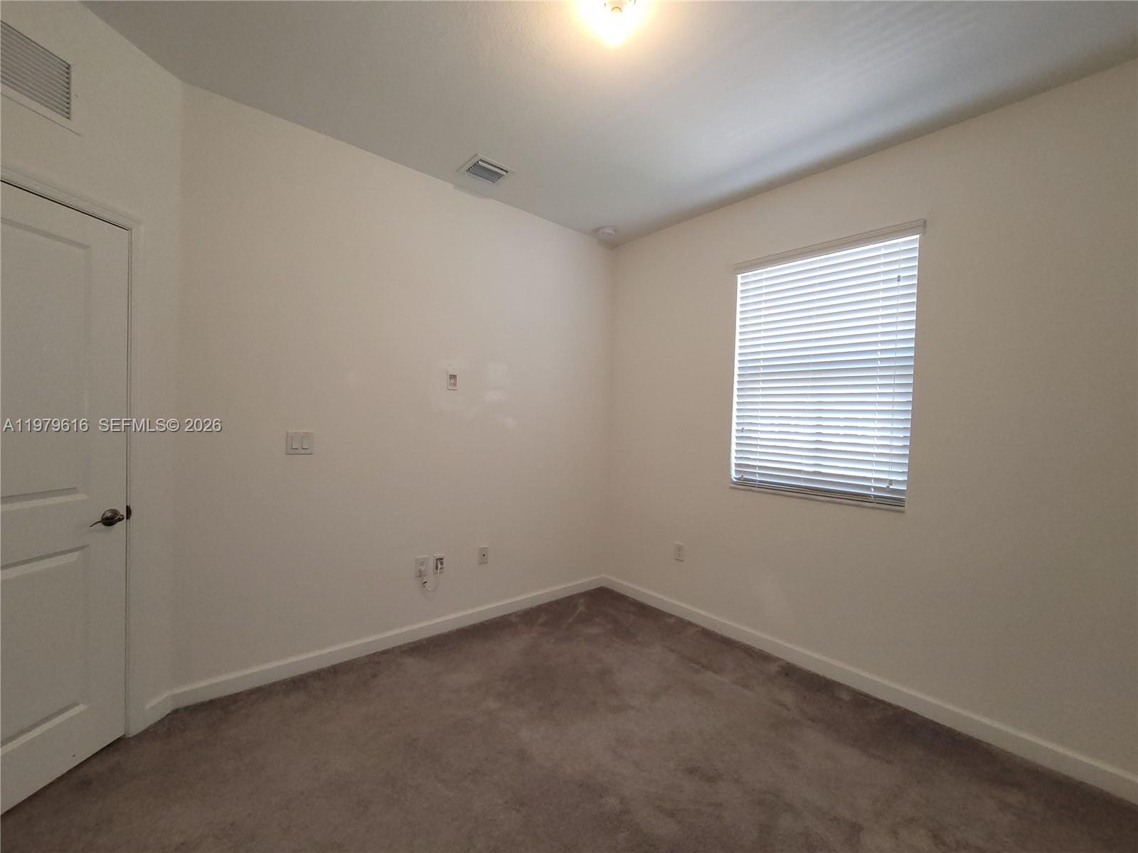 25039 Southwest 114th Avenue Homestead, FL 33032 - Photo 39 of 45 an empty room with a window