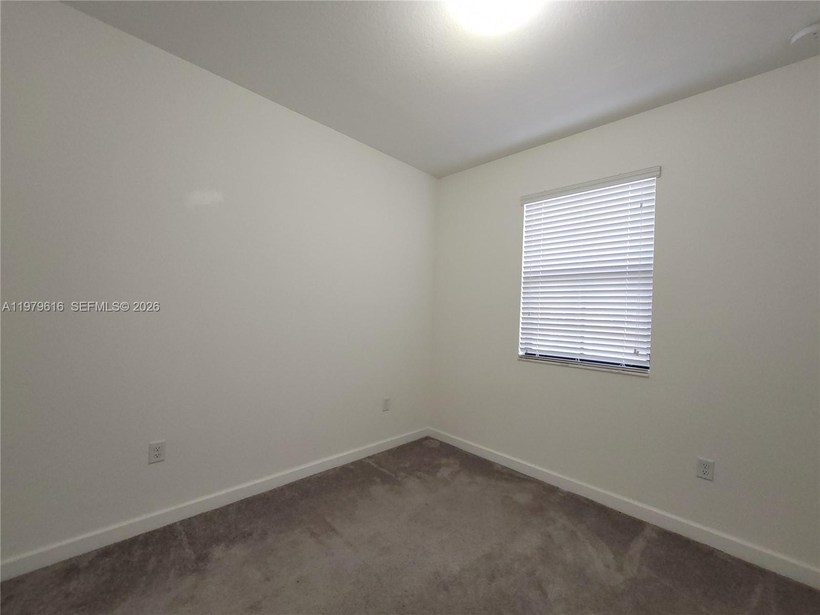 25039 Southwest 114th Avenue Homestead, FL 33032 - Photo 41 of 45 an empty room with a window