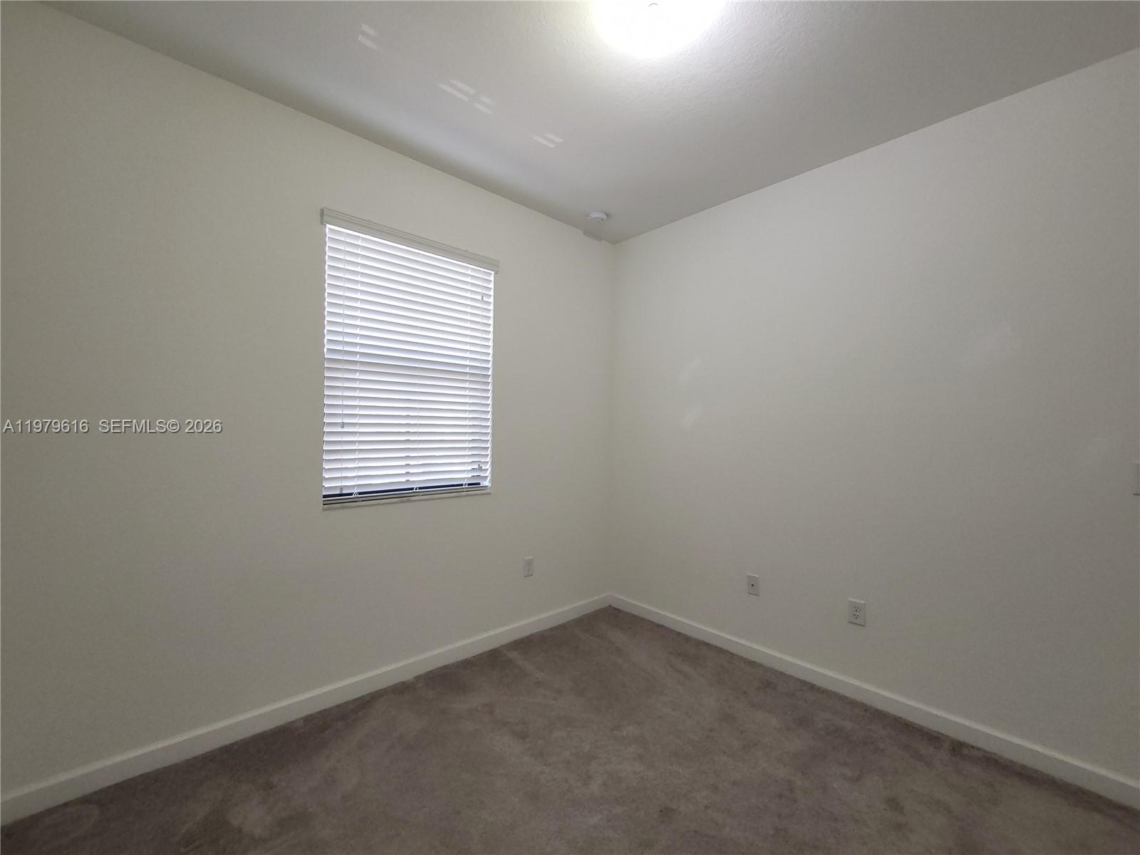 25039 Southwest 114th Avenue Homestead, FL 33032 - Photo 42 of 45 an empty room with a window
