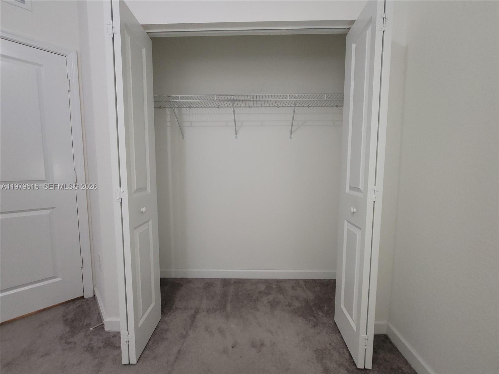 25039 Southwest 114th Avenue Homestead, FL 33032 - Photo 45 of 45 an empty room with wooden door