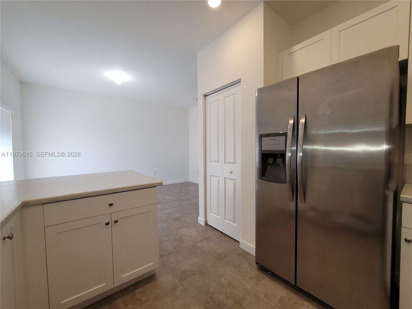 25039 Southwest 114th Avenue Homestead, FL 33032 - Photo 5 of 45 a kitchen with cabinets and refrigerator