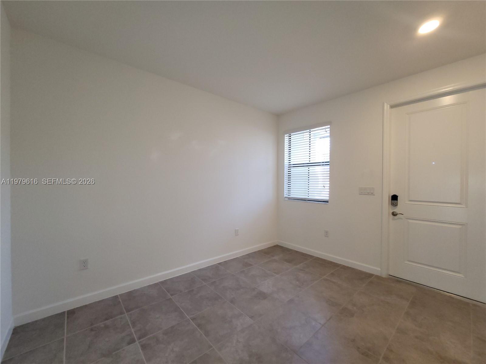 25039 Southwest 114th Avenue Homestead, FL 33032 - Photo 8 of 45 an empty room with windows