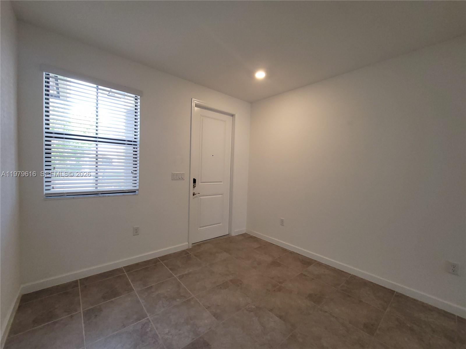 25039 Southwest 114th Avenue Homestead, FL 33032 - Photo 9 of 45 an empty room with windows