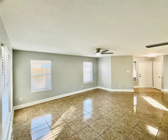 an empty room with windows and natural light
