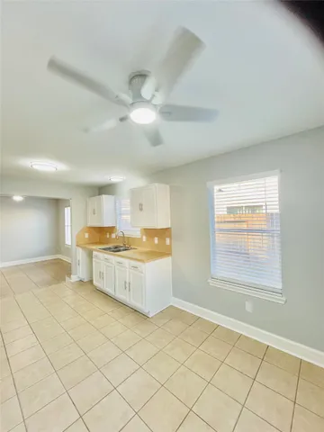 a large room with a window and fireplace