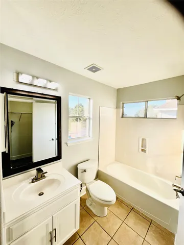 a bathroom with a sink a toilet and bathtub