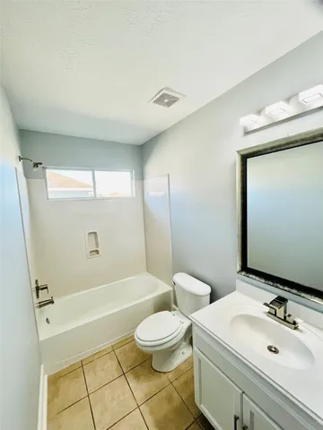 a view of a yard with wooden fence