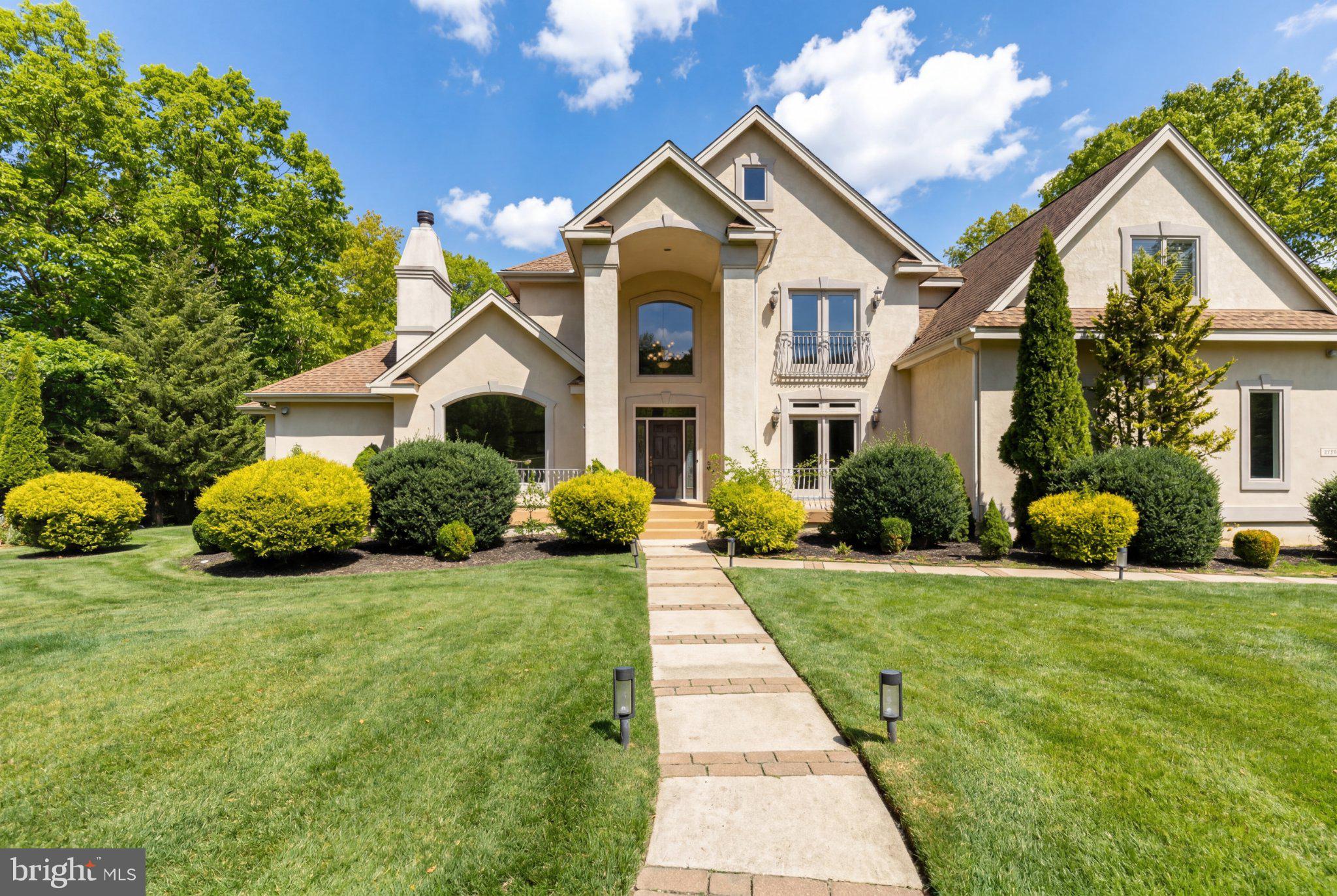 Elegant home with lush landscaping.