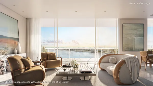 a living room with furniture and large windows