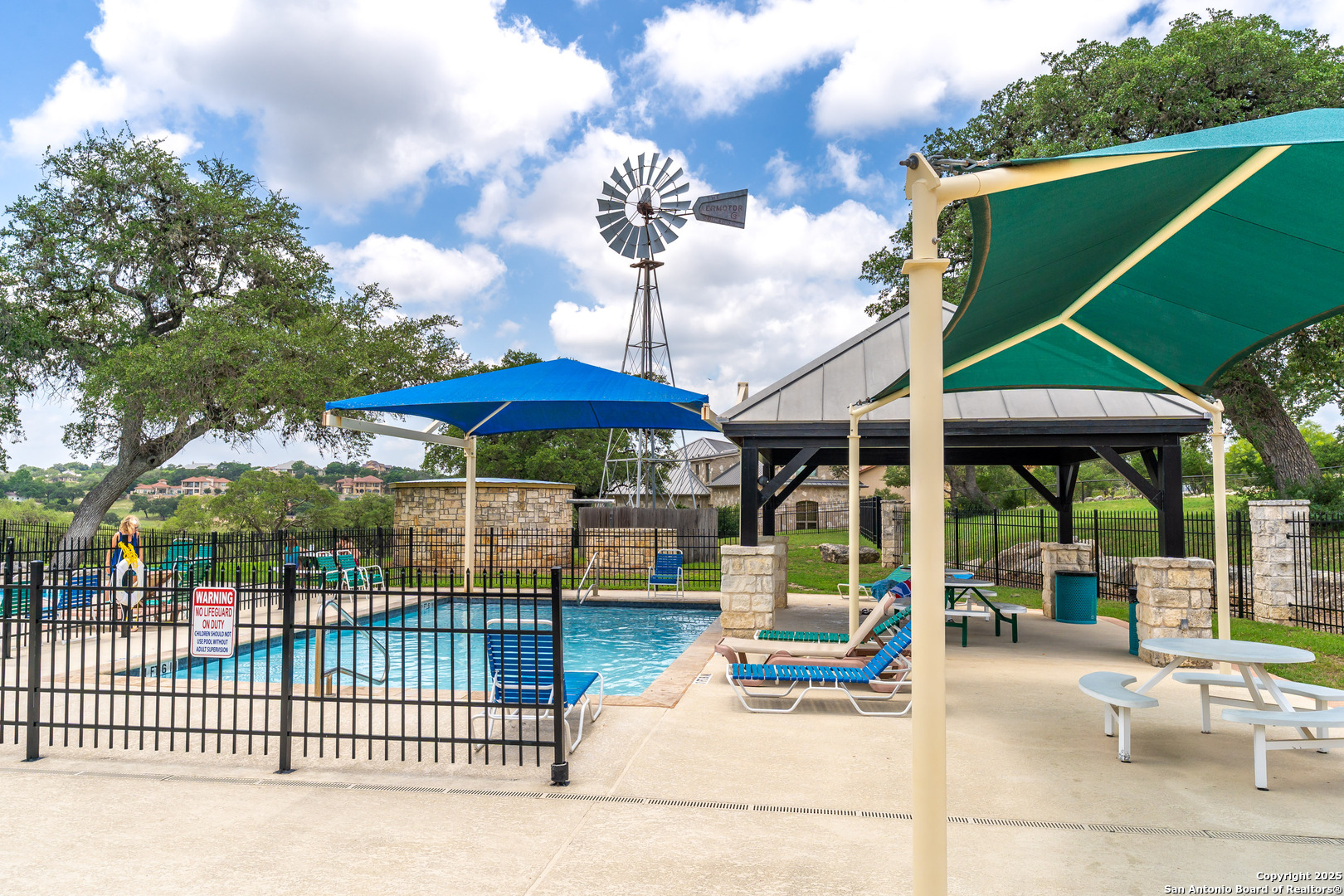 473 Mystic Parkway Spring Branch, TX 78070 - Photo 22 of 23 a view of a patio with a table and chairs under an umbrella
