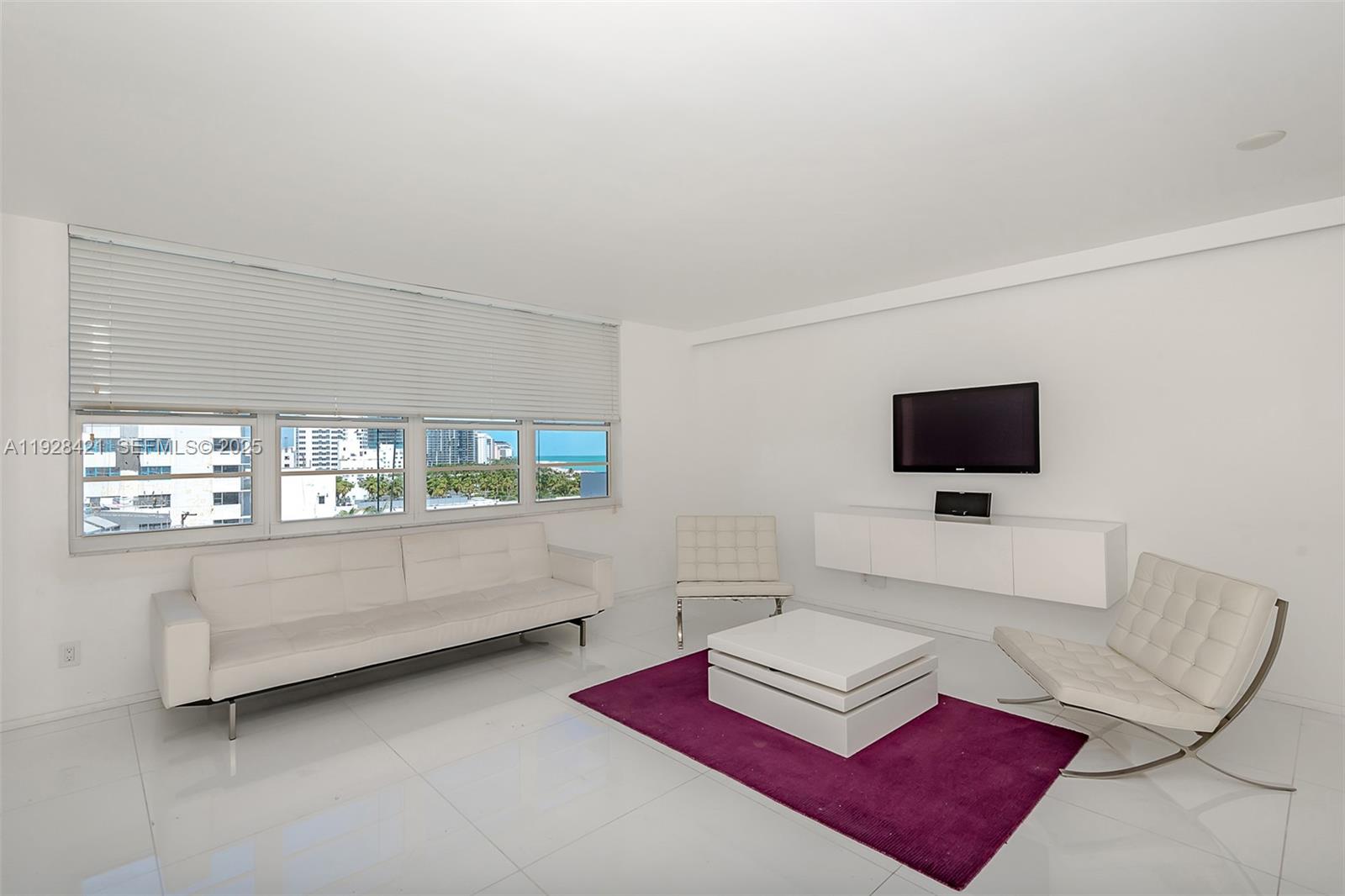 100 Lincoln Road, Unit 839 Miami Beach, FL 33139 - Photo 12 of 26 a living room with furniture and a flat screen tv