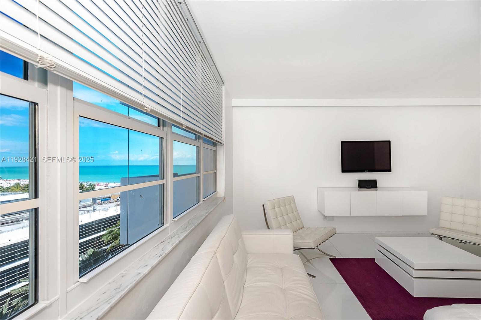 100 Lincoln Road, Unit 839 Miami Beach, FL 33139 - Photo 13 of 26 a living room with furniture and a flat screen tv