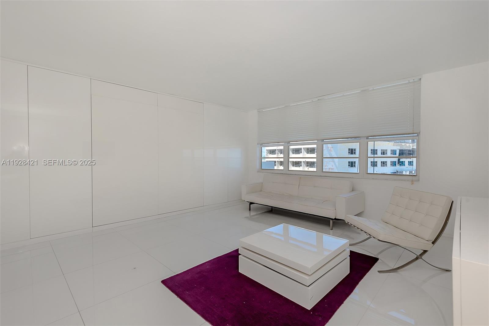 100 Lincoln Road, Unit 839 Miami Beach, FL 33139 - Photo 14 of 26 a living room with furniture and a window