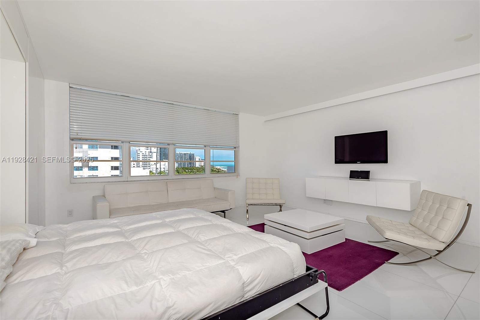 100 Lincoln Road, Unit 839 Miami Beach, FL 33139 - Photo 17 of 26 a bedroom with a bed window and flat screen tv