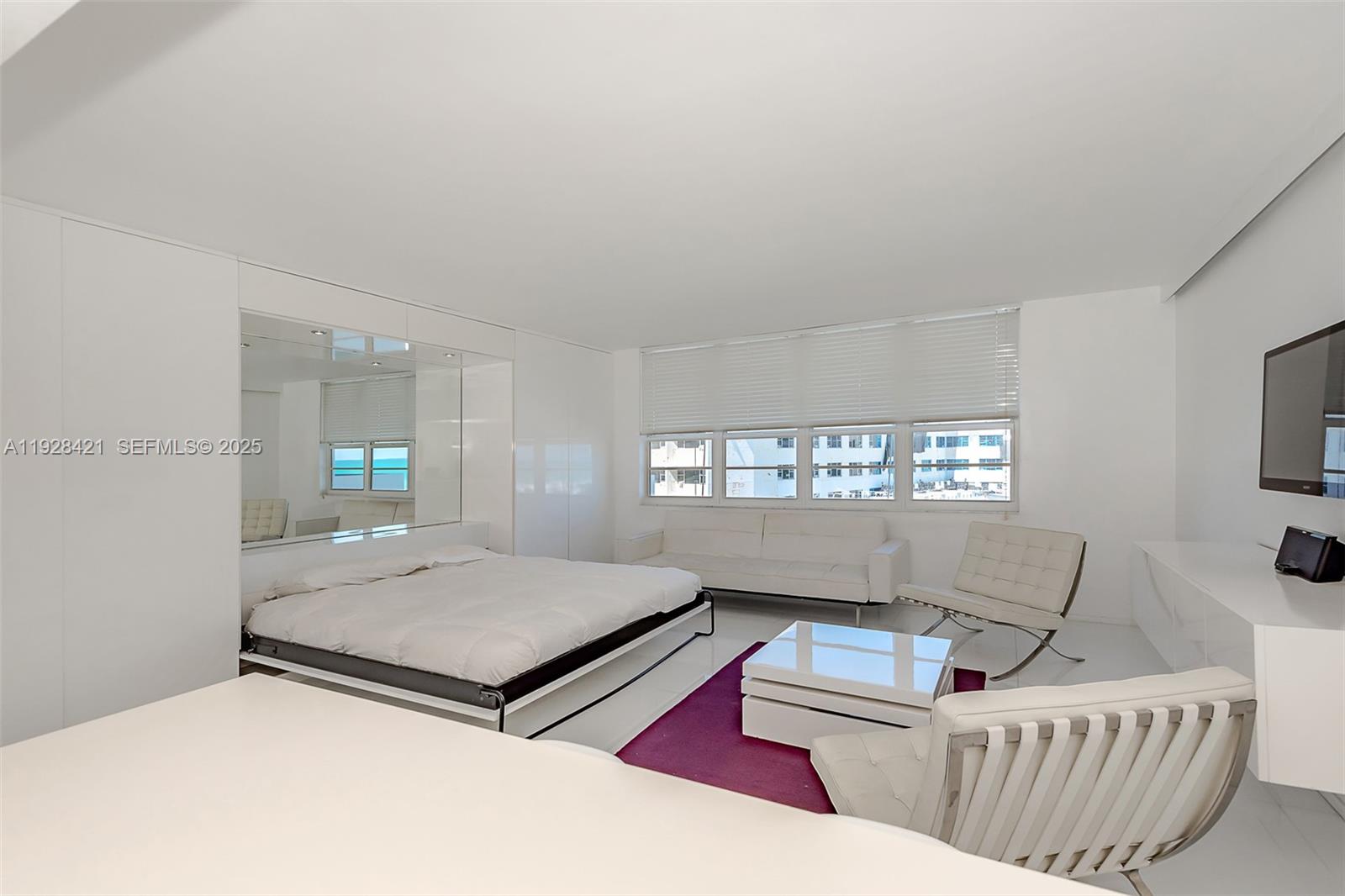 100 Lincoln Road, Unit 839 Miami Beach, FL 33139 - Photo 18 of 26 a living room with furniture and a flat screen tv