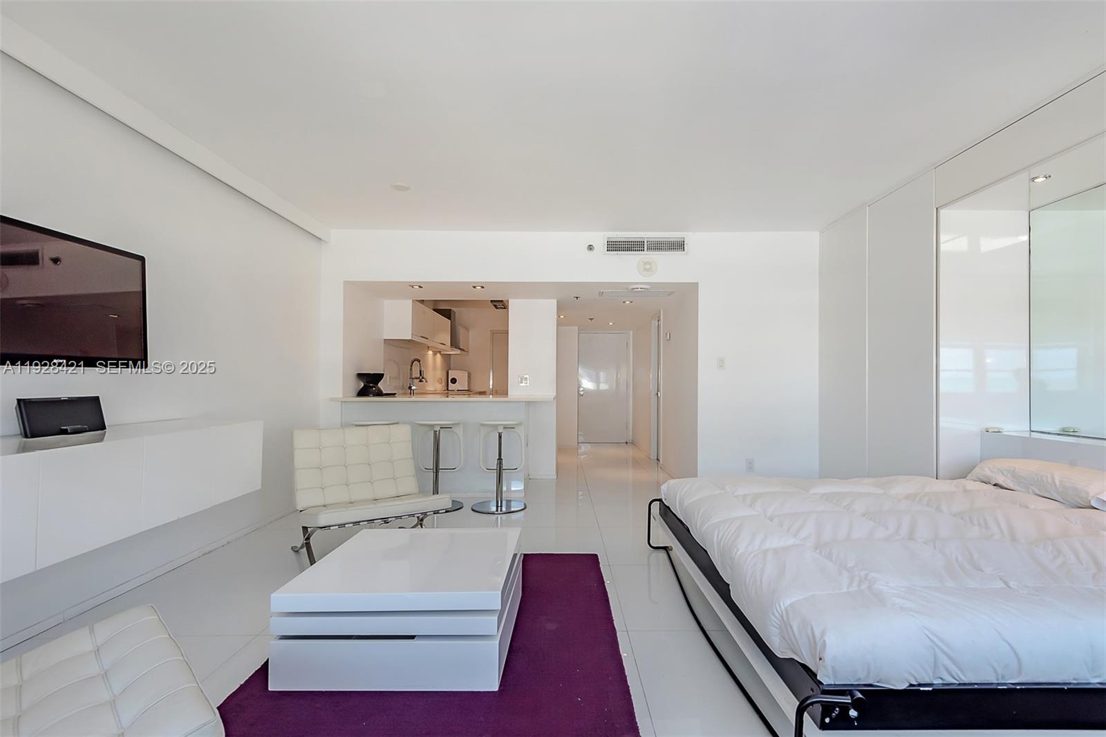 100 Lincoln Road, Unit 839 Miami Beach, FL 33139 - Photo 21 of 26 a living room with furniture and a flat screen tv