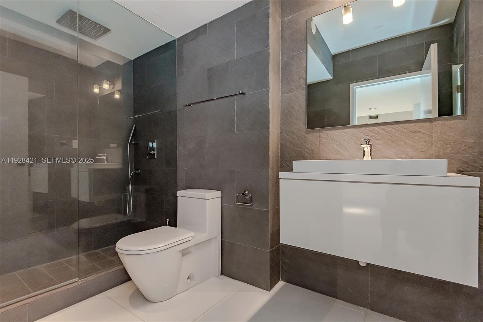 100 Lincoln Road, Unit 839 Miami Beach, FL 33139 - Photo 25 of 26 a bathroom with a toilet sink and shower
