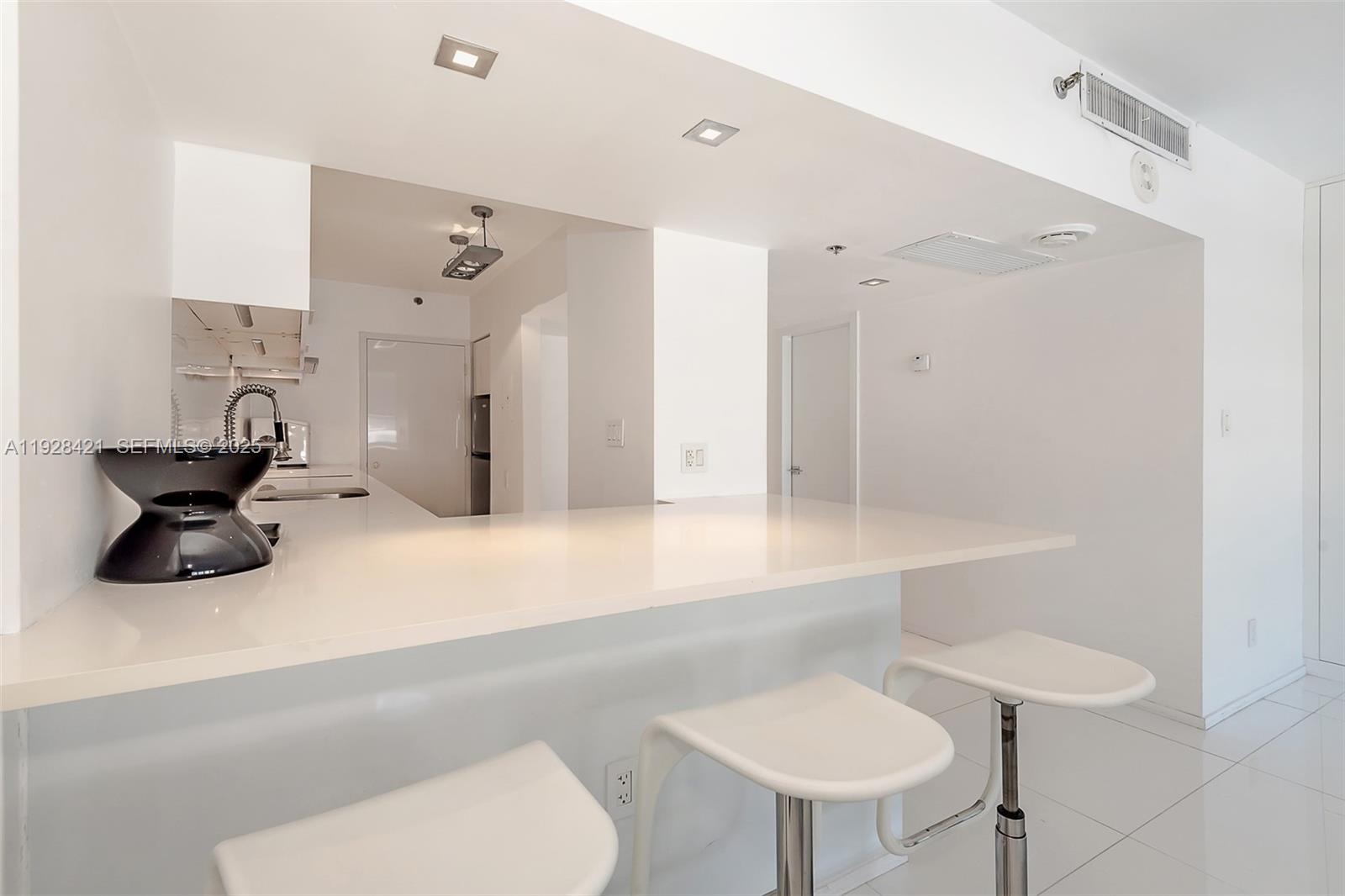 100 Lincoln Road, Unit 839 Miami Beach, FL 33139 - Photo 5 of 26 a bathroom with a sink mirror and toilet
