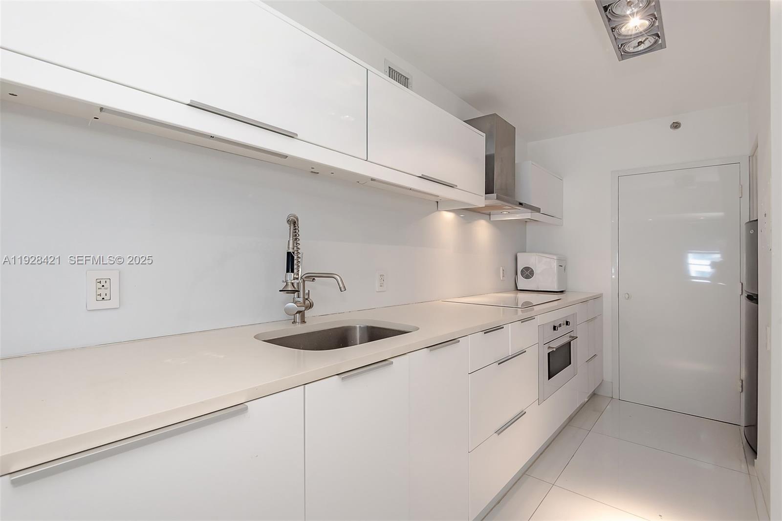 100 Lincoln Road, Unit 839 Miami Beach, FL 33139 - Photo 6 of 26 a kitchen with stainless steel appliances granite countertop a sink and a stove