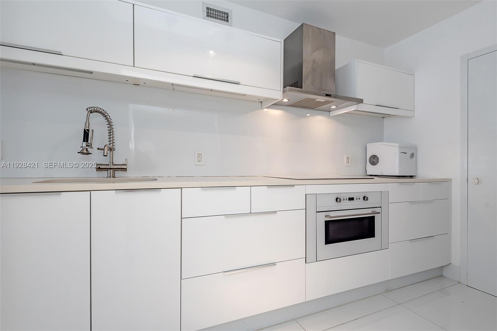 100 Lincoln Road, Unit 839 Miami Beach, FL 33139 - Photo 7 of 26 a close view of kitchen stove sink and microwave