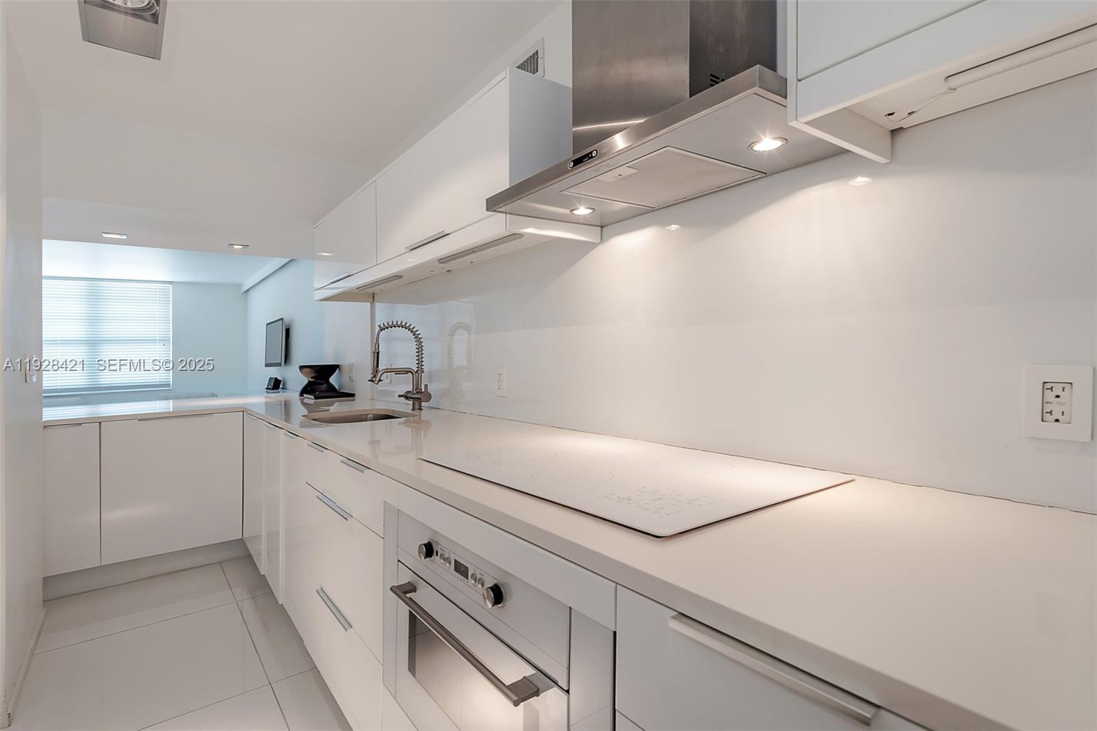 100 Lincoln Road, Unit 839 Miami Beach, FL 33139 - Photo 8 of 26 a kitchen with a sink and cabinets