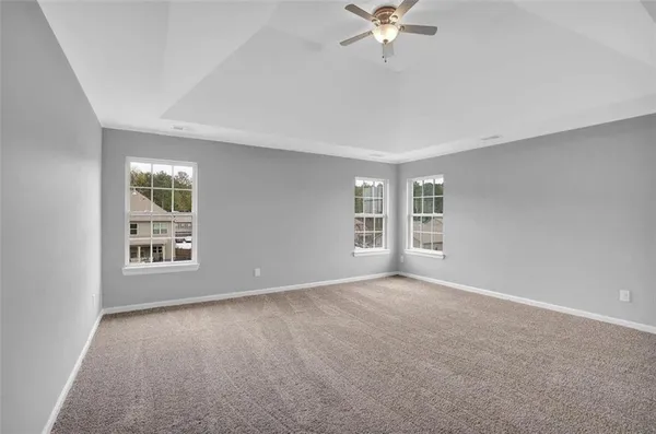 a view of a livingroom with a ceiling fan & a ceiling fan