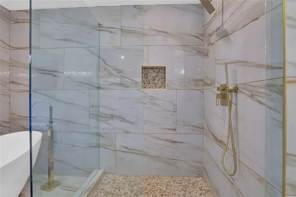 a bathroom with a bathtub and shower
