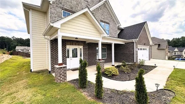 a front view of a house with garden