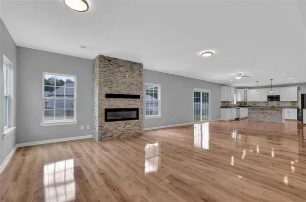 a kitchen with stainless steel appliances granite countertop a stove top oven microwave and sink