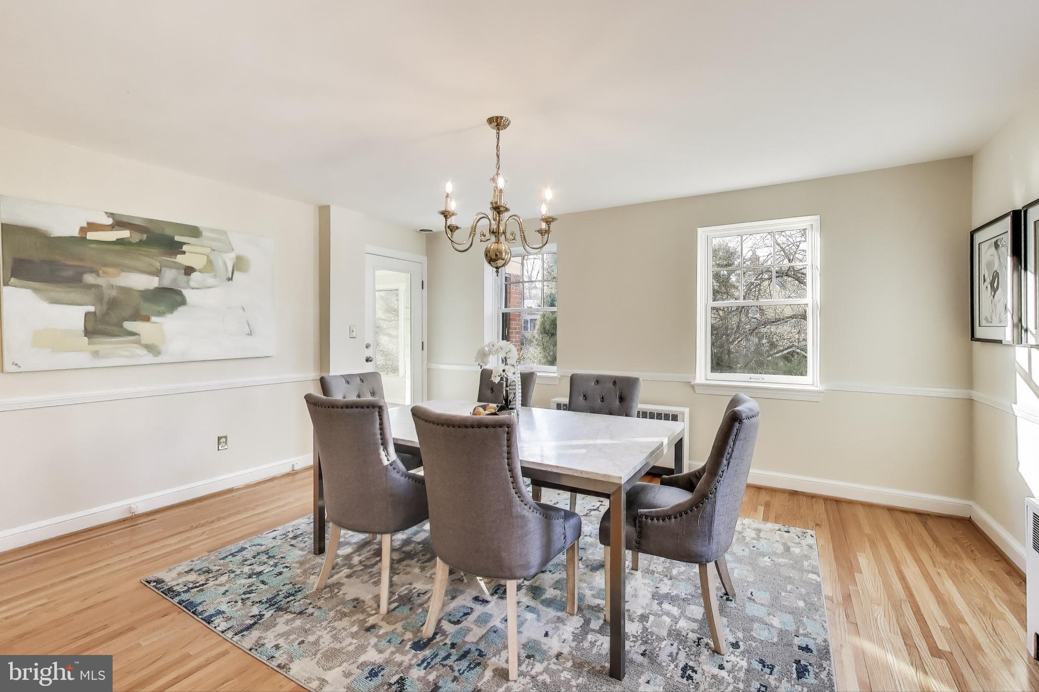9214 Kingsbury Drive Silver Spring, MD 20910 - Photo 15 of 67 a view of a dining room with furniture and wooden floor