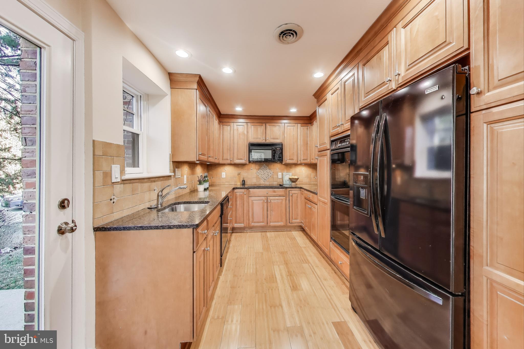9214 Kingsbury Drive Silver Spring, MD 20910 - Photo 17 of 67 a kitchen with granite countertop a refrigerator and a sink