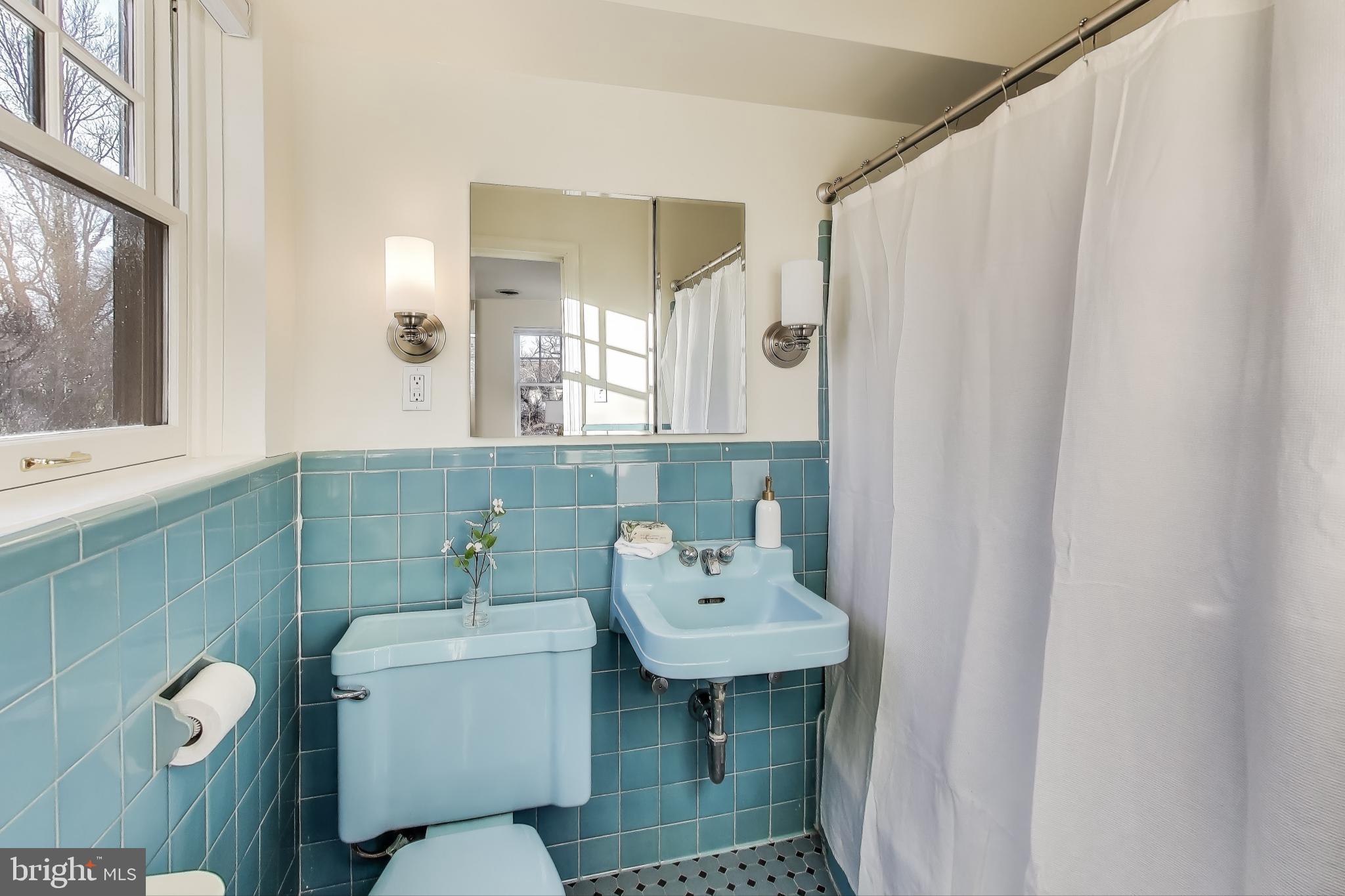 9214 Kingsbury Drive Silver Spring, MD 20910 - Photo 23 of 67 a bathroom with a sink toilet and mirror