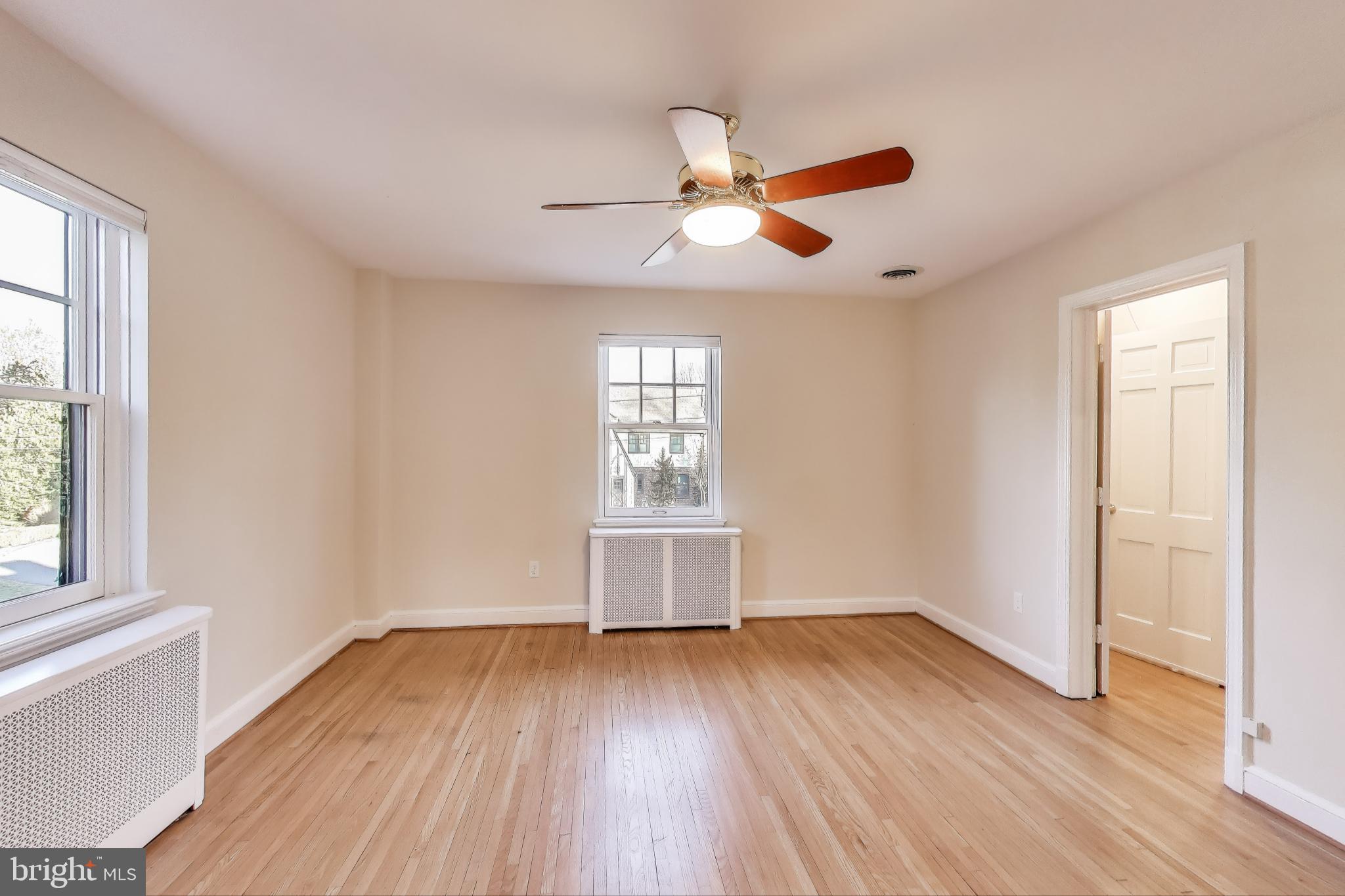 9214 Kingsbury Drive Silver Spring, MD 20910 - Photo 24 of 67 a view of empty room with wooden floor and fan