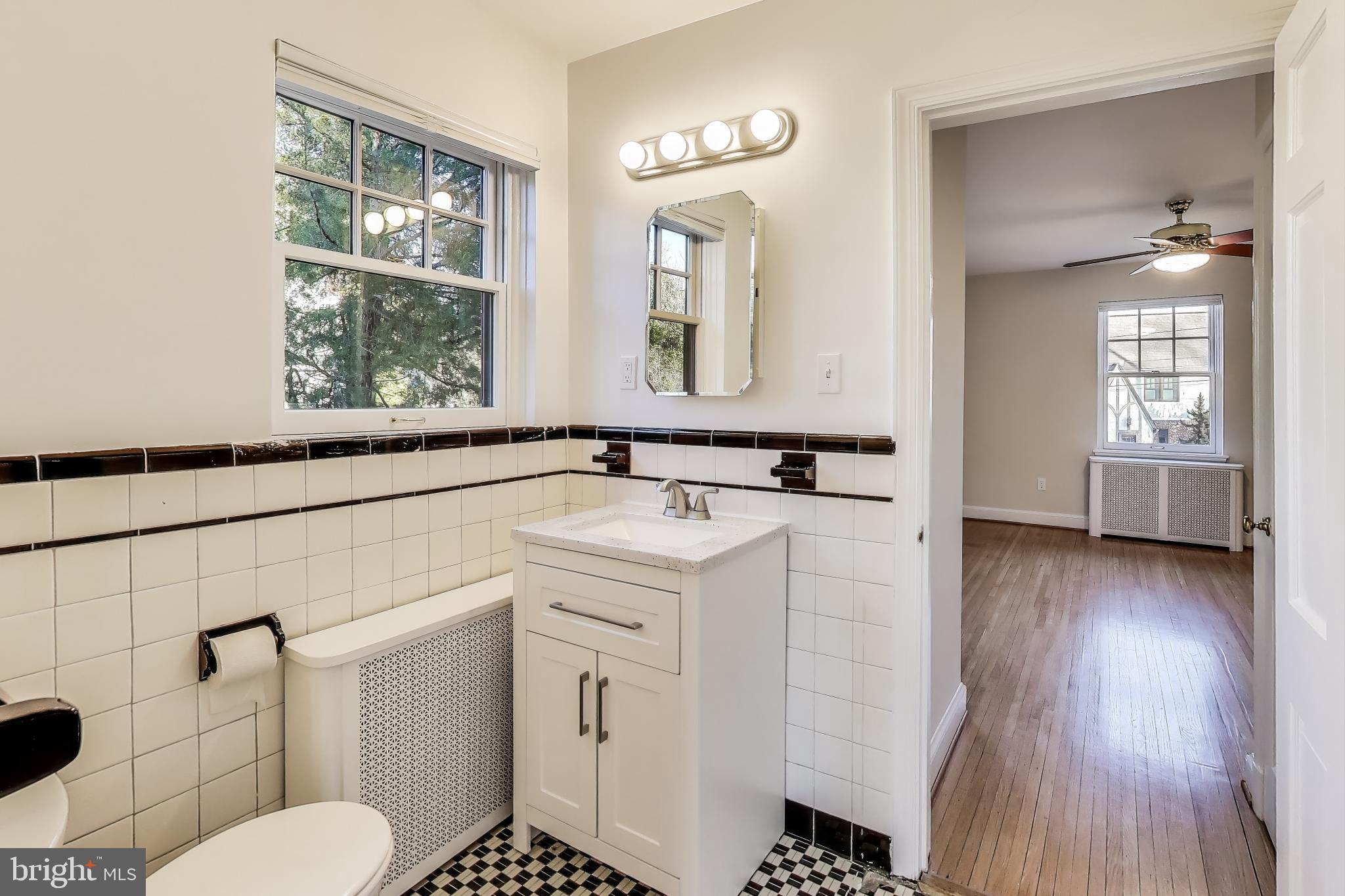 9214 Kingsbury Drive Silver Spring, MD 20910 - Photo 26 of 67 a bathroom with a sink and a mirror