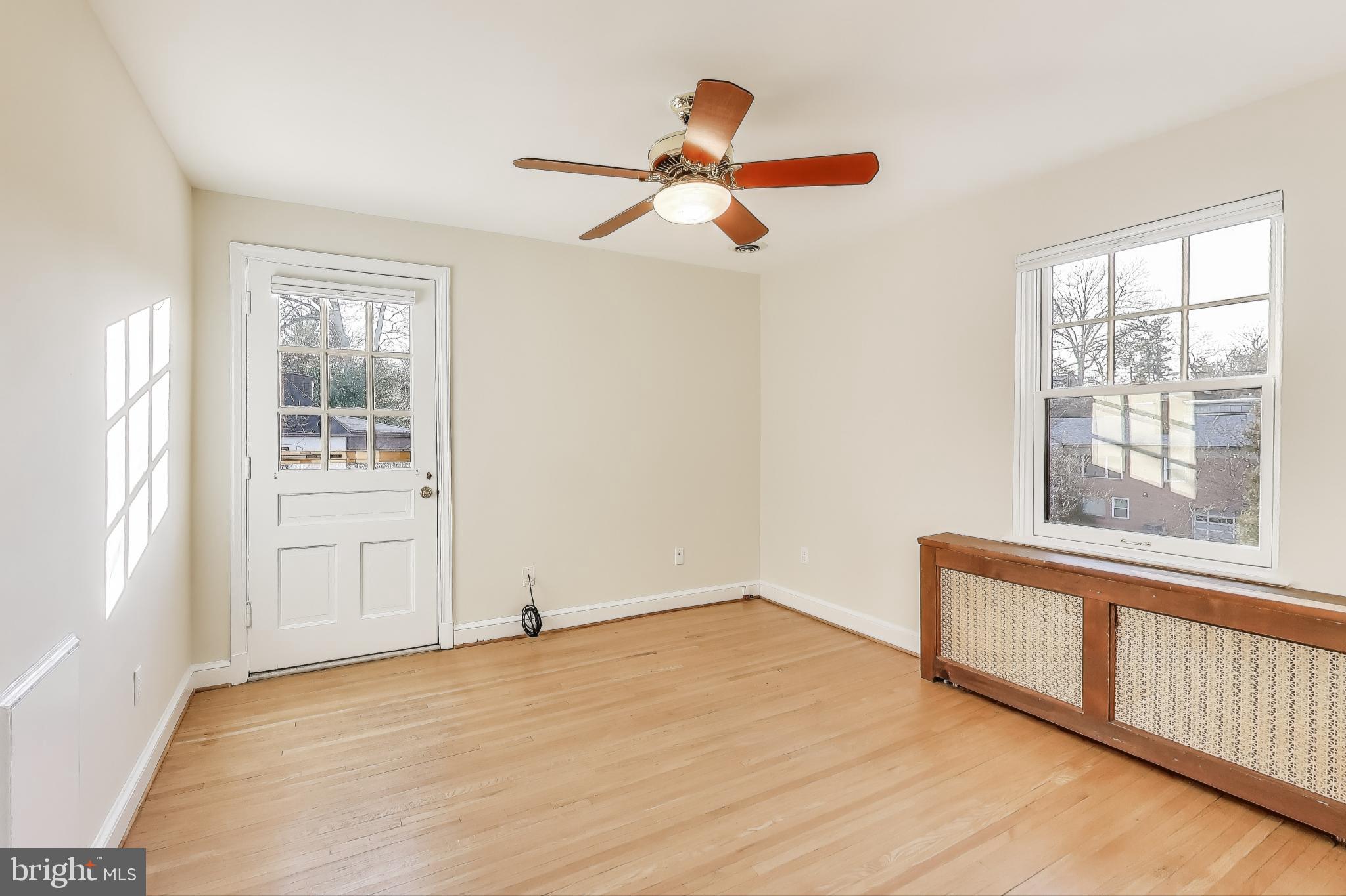 9214 Kingsbury Drive Silver Spring, MD 20910 - Photo 30 of 67 a view of empty room with wooden floor and fan
