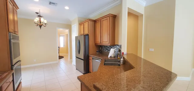 a living room with furniture a flat screen tv and a floor to ceiling window