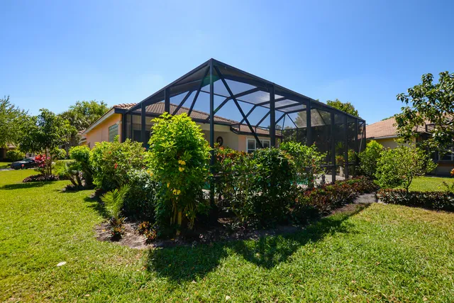 a view of a house with a yard and plants